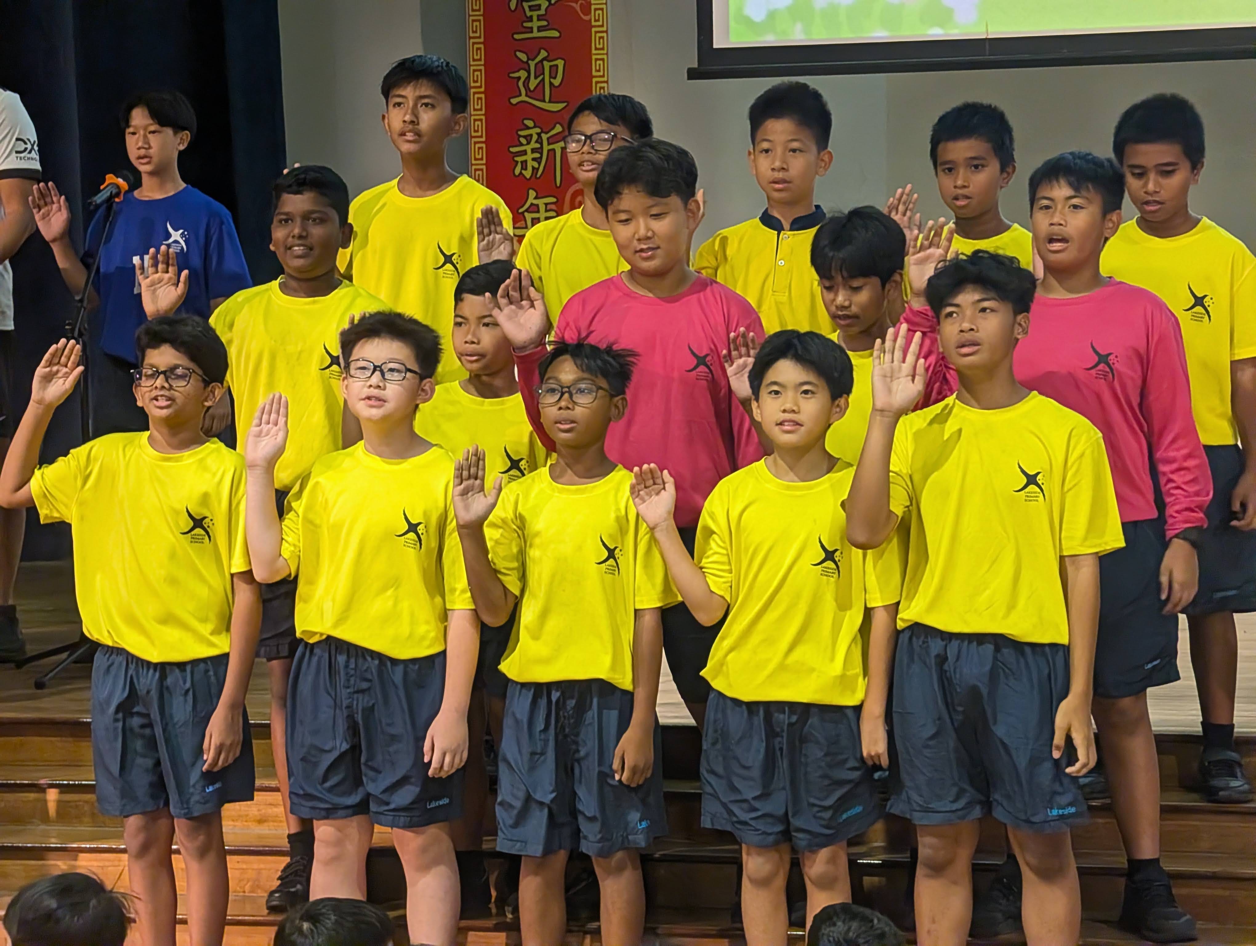 Football Senior Boys taking part in the Athlete's Oath on stage